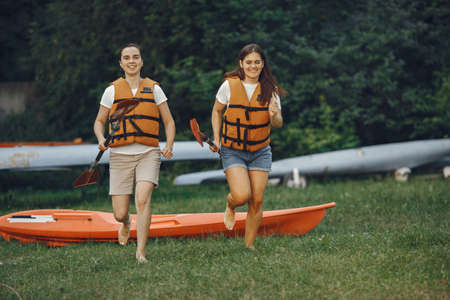 Women prepare to paddling on a lake in a kayakの写真素材