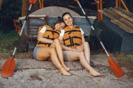 Women prepare to paddling on a lake in a kayakの写真素材