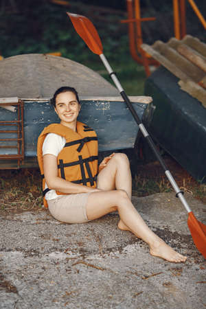 Woman prepare to paddling on a lake in a kayakの写真素材
