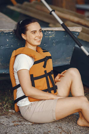 Woman prepare to paddling on a lake in a kayakの写真素材