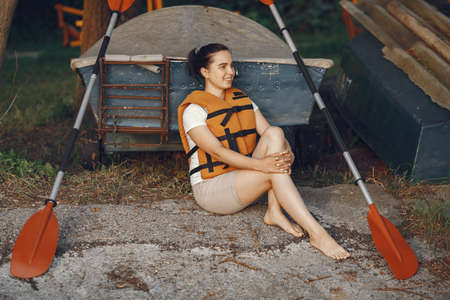 Woman prepare to paddling on a lake in a kayakの写真素材