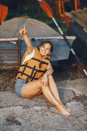 Woman prepare to paddling on a lake in a kayakの写真素材