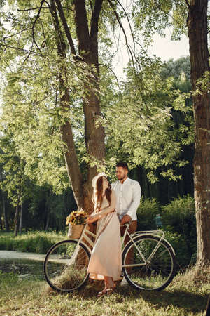 Couple with vintage bicycle in the summer parkの写真素材