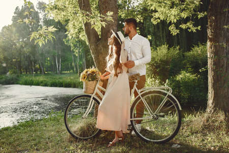 Couple with vintage bicycle in the summer parkの写真素材