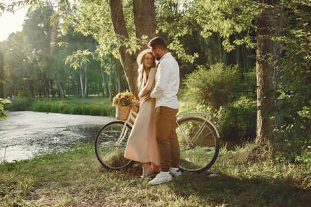 Couple with vintage bicycle in the summer parkの写真素材