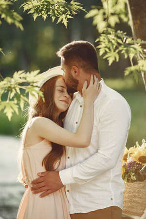 Beautiful couple spend time on a summer fieldの写真素材