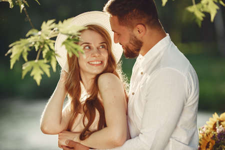 Beautiful couple spend time on a summer fieldの写真素材