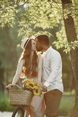 Couple with vintage bicycle in the summer parkの写真素材