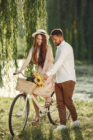 Couple with vintage bicycle in the summer parkの写真素材