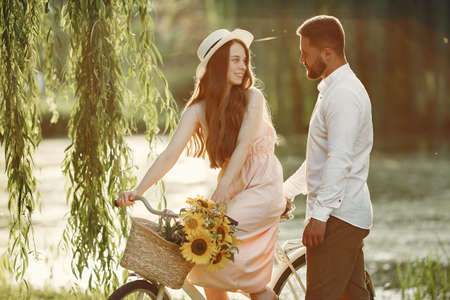 Couple with vintage bicycle in the summer parkの写真素材