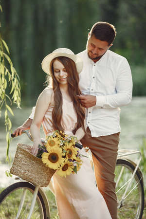Couple with vintage bicycle in the summer parkの写真素材