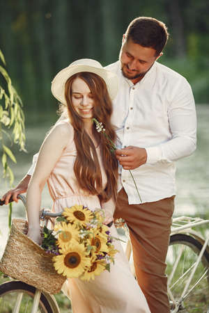 Couple with vintage bicycle in the summer parkの写真素材