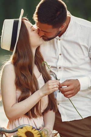 Couple with vintage bicycle in the summer parkの写真素材