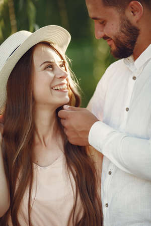 Beautiful couple spend time on a summer fieldの写真素材