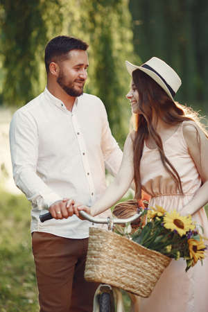 Couple with vintage bicycle in the summer parkの写真素材
