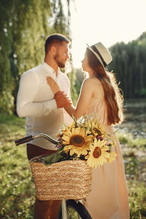 Couple with vintage bicycle in the summer parkの写真素材
