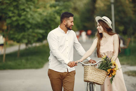 Couple with vintage bicycle in the summer parkの写真素材