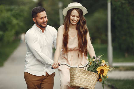 Couple with vintage bicycle in the summer parkの写真素材