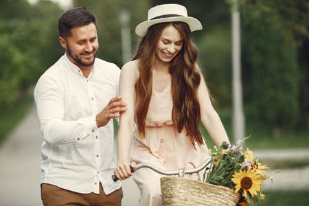 Couple with vintage bicycle in the summer parkの写真素材