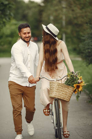 Couple with vintage bicycle in the summer parkの写真素材