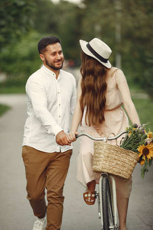 Couple with vintage bicycle in the summer parkの写真素材