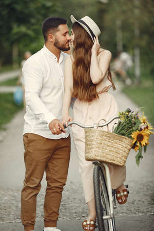 Couple with vintage bicycle in the summer parkの写真素材