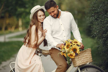 Couple with vintage bicycle in the summer parkの写真素材