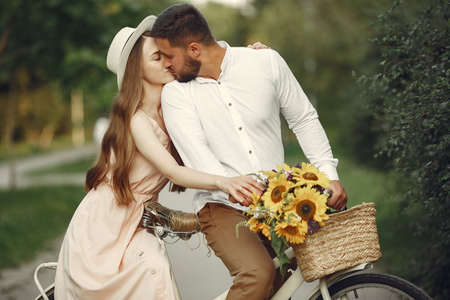 Couple with vintage bicycle in the summer parkの写真素材