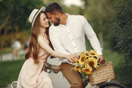 Couple with vintage bicycle in the summer parkの写真素材