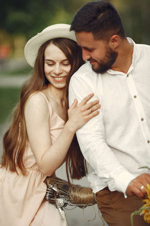Couple with vintage bicycle in the summer parkの写真素材