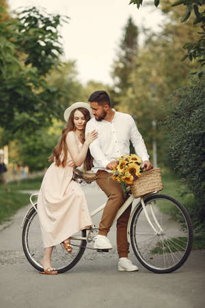 Couple with vintage bicycle in the summer parkの写真素材