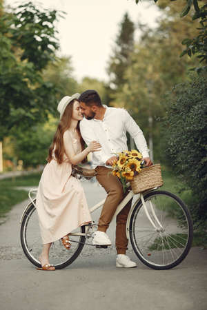 Couple with vintage bicycle in the summer parkの写真素材