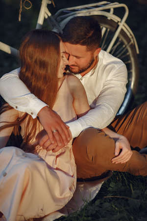 Couple with vintage bicycle in the summer parkの写真素材