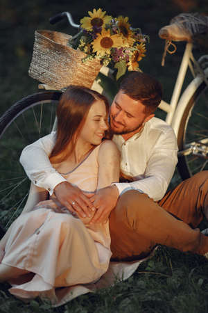 Couple with vintage bicycle in the summer parkの写真素材