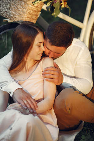 Beautiful couple spend time on a summer fieldの写真素材