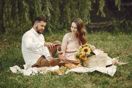 Beautiful couple spend time on a summer fieldの写真素材