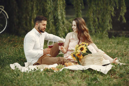 Beautiful couple spend time on a summer fieldの写真素材
