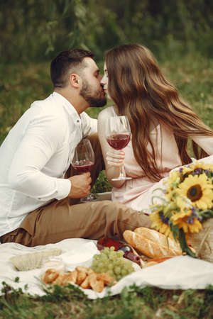 Beautiful couple spend time on a summer fieldの写真素材