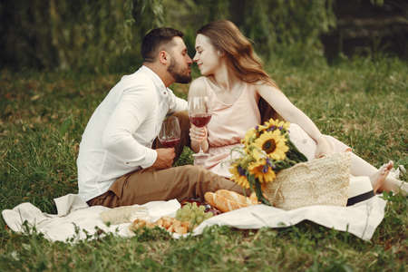 Beautiful couple spend time on a summer fieldの写真素材