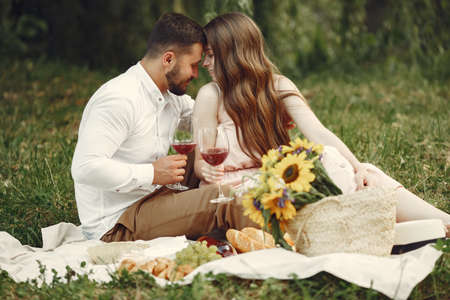 Beautiful couple spend time on a summer fieldの写真素材