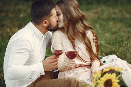 Beautiful couple spend time on a summer fieldの写真素材