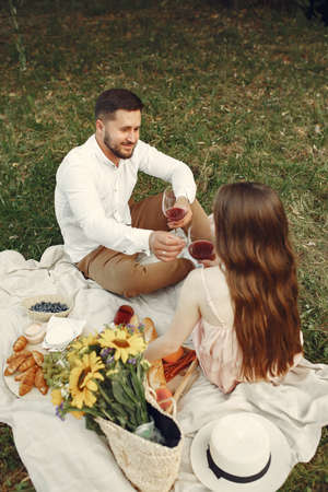 Beautiful couple spend time on a summer fieldの写真素材