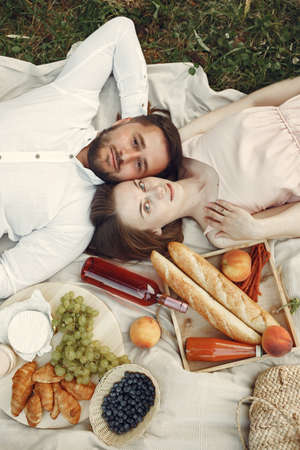 Beautiful couple spend time on a summer fieldの写真素材