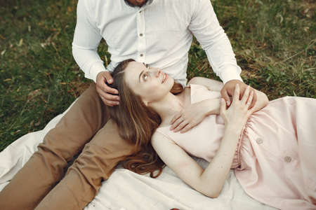 Beautiful couple spend time on a summer fieldの写真素材
