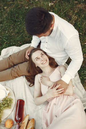 Beautiful couple spend time on a summer fieldの写真素材