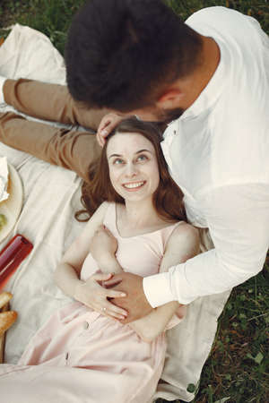 Beautiful couple spend time on a summer fieldの写真素材