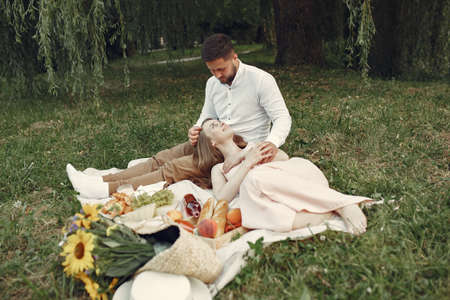Beautiful couple spend time on a summer fieldの写真素材