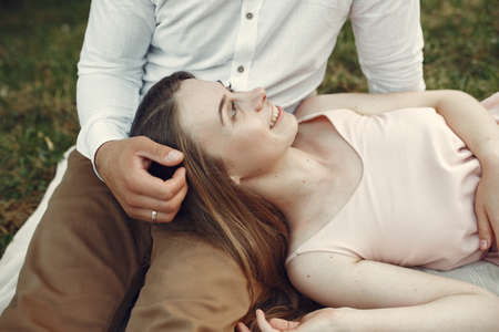 Beautiful couple spend time on a summer fieldの写真素材