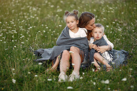 Mother with son and daughter resting in the park.の写真素材