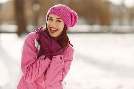 Woman in winter sports clothes looking at cameraの写真素材